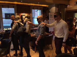 Image of blindfolded guests being led in by host Raheem